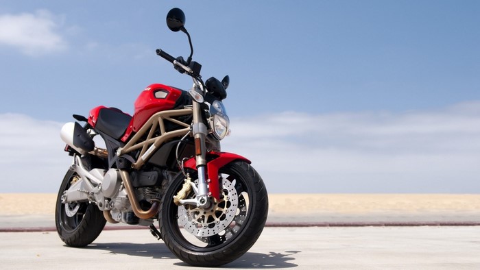 Red Ducati Monster Motorcycle on a Beach
