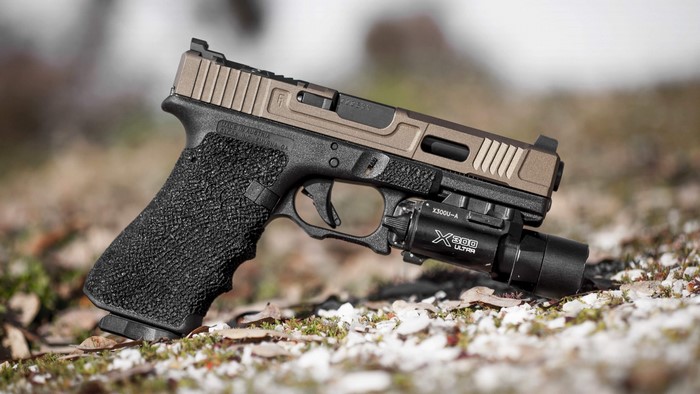 Glock pistol with tactical flashlight