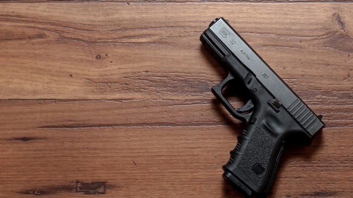 Glock 32 pistol on a wooden surface