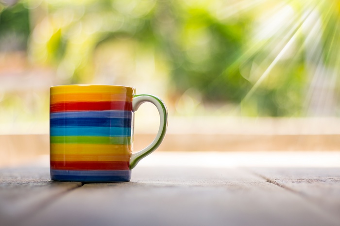 Colorful striped mug on a wooden table