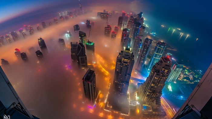 Aerial view of Dubai skyscrapers in fog at night