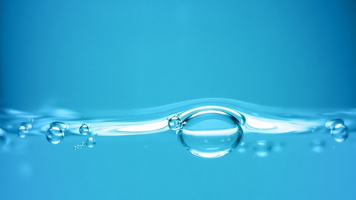 Blue water with air bubbles close up