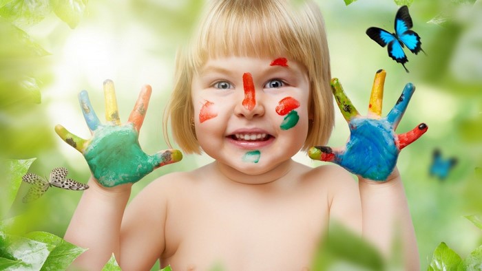 Baby with face and hand paint and butterflies