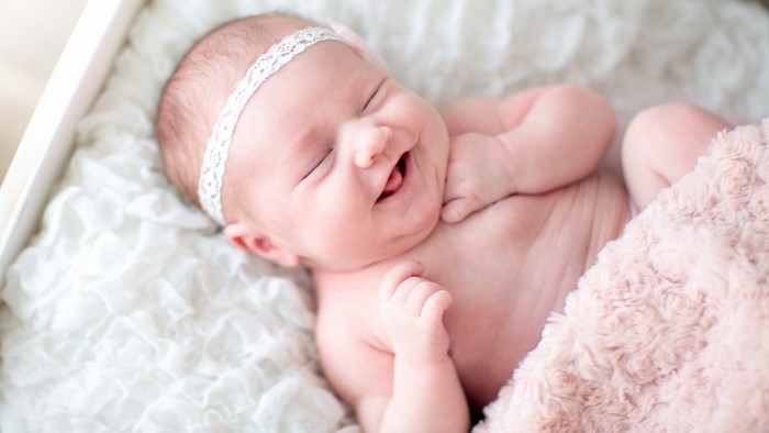 Baby smiling with a headband