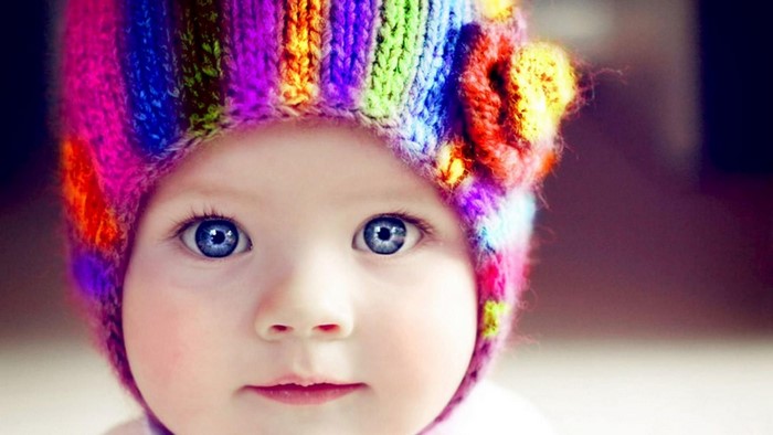 Baby wearing a colorful knitted hat