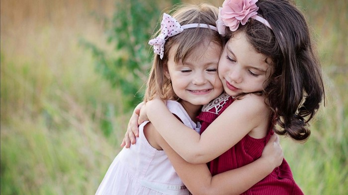 Two cute baby girls hugging