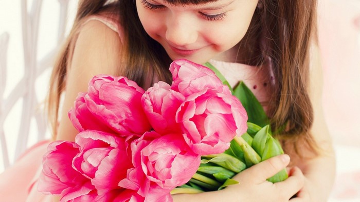 Girl holding pink tulips