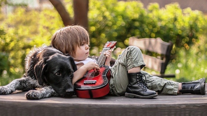 Boy with dog and guitar