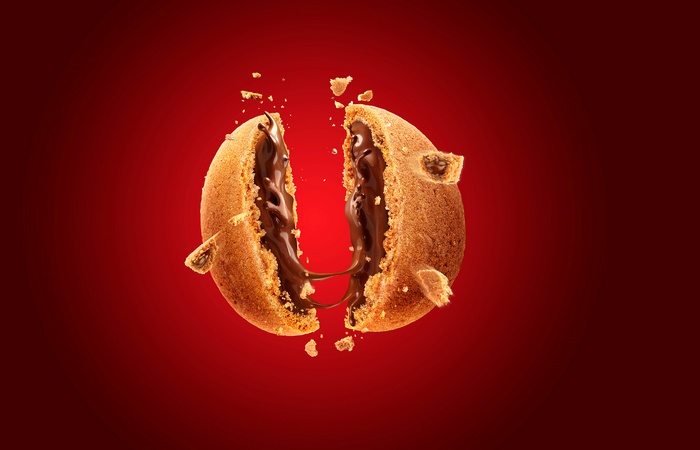 Chocolate cookie broken in half with molten chocolate