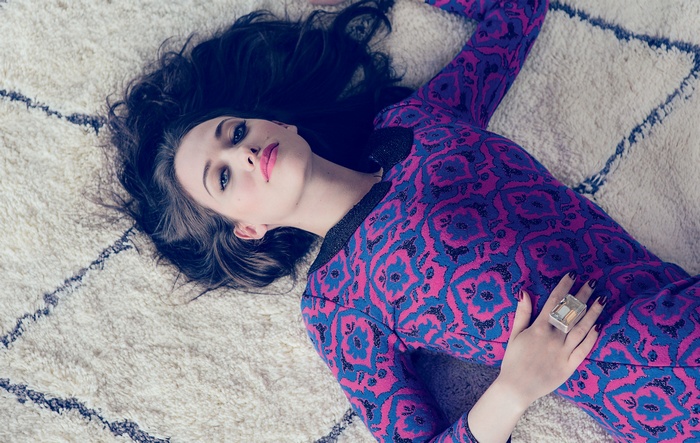 Kat Dennings lying on a rug