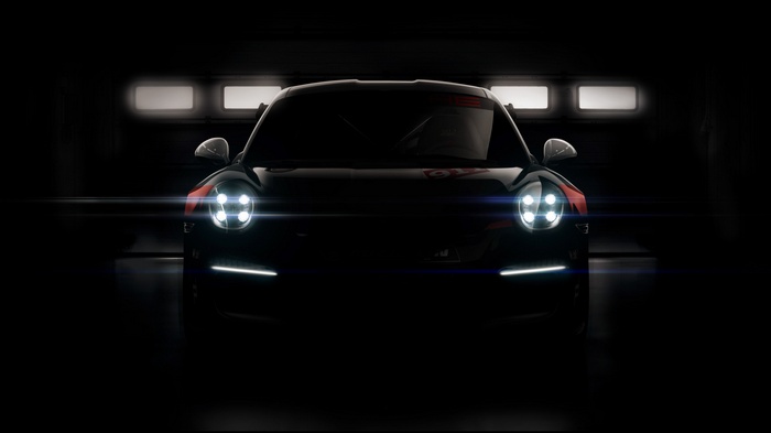 Porsche 911 GT3 RSR in a dark garage
