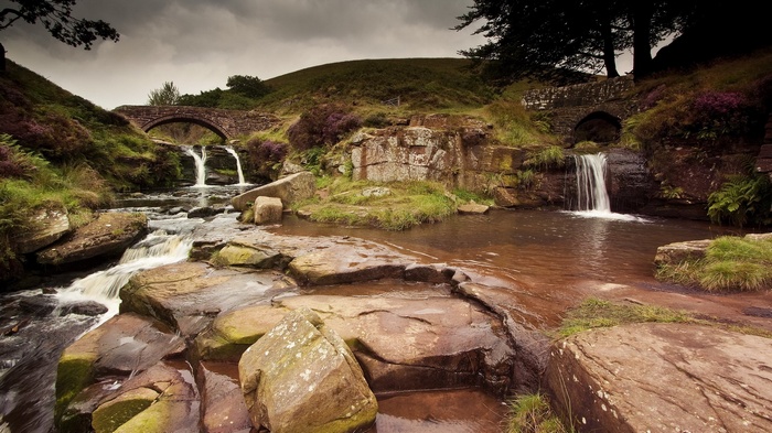 Stone bridges over waterfalls in a rocky landscape