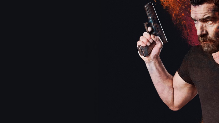 Antonio Banderas holding a gun