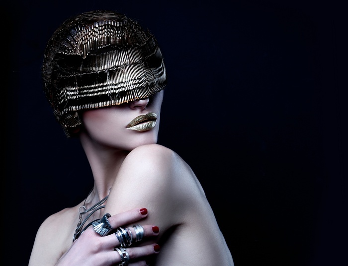 Woman with metallic headpiece and gold lips
