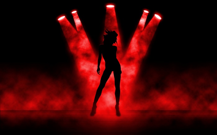 Silhouette of a dancer under red spotlights