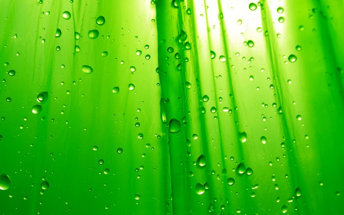 Green surface with water droplets