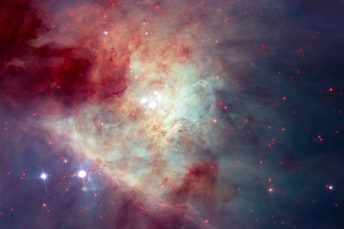 Orion Nebula with bright stars and red gas clouds