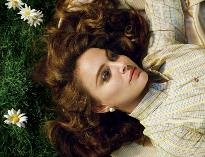Natalie Portman lying on grass with daisies