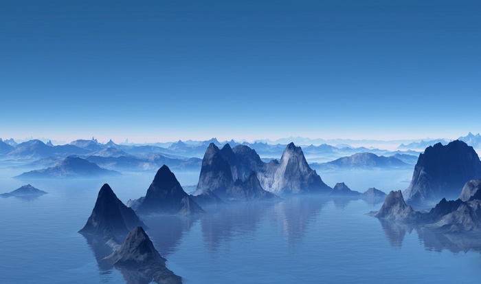 Misty mountains rise from a calm ocean under a clear blue sky.