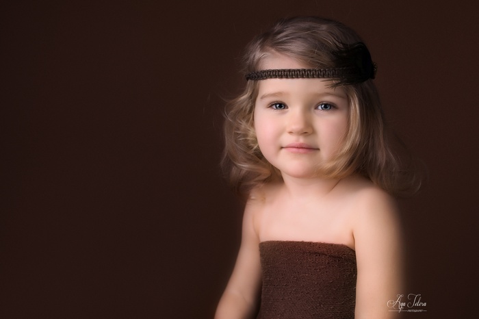 Cute girl with headband and brown dress