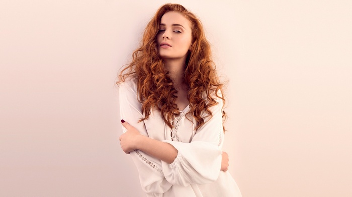 Sophie Turner with long curly red hair