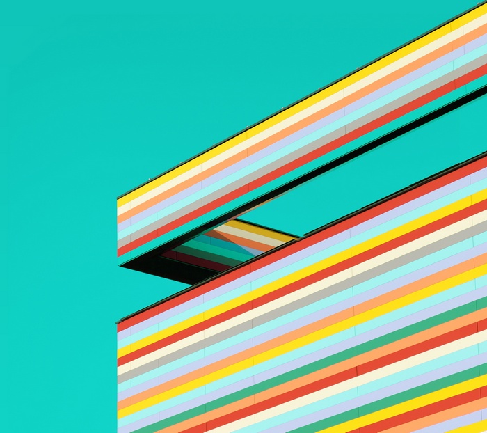 Colorful striped building against a teal sky