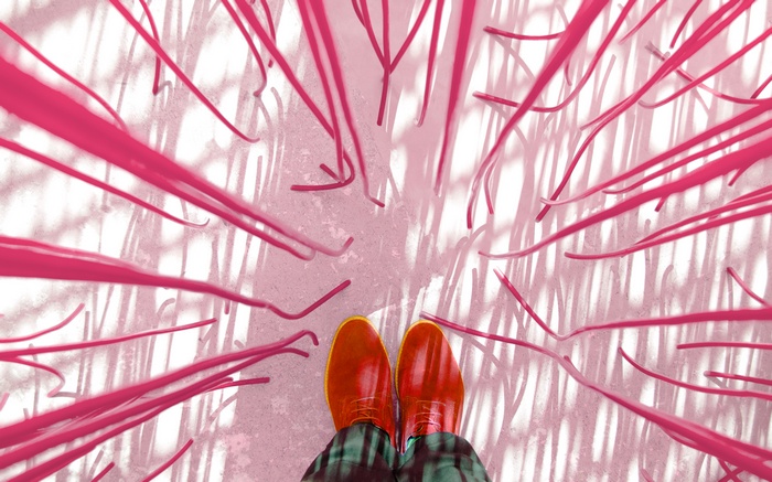 Person wearing red shoes surrounded by pink strings