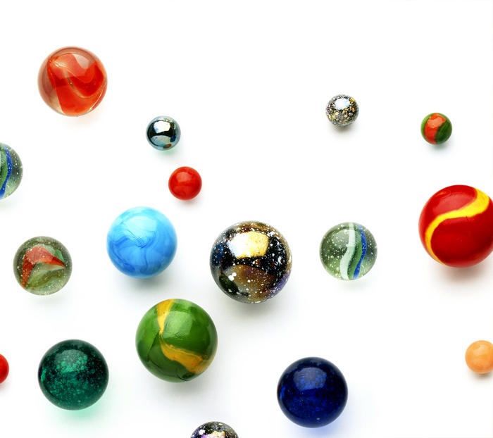 Collection of colorful glass marbles on a white background