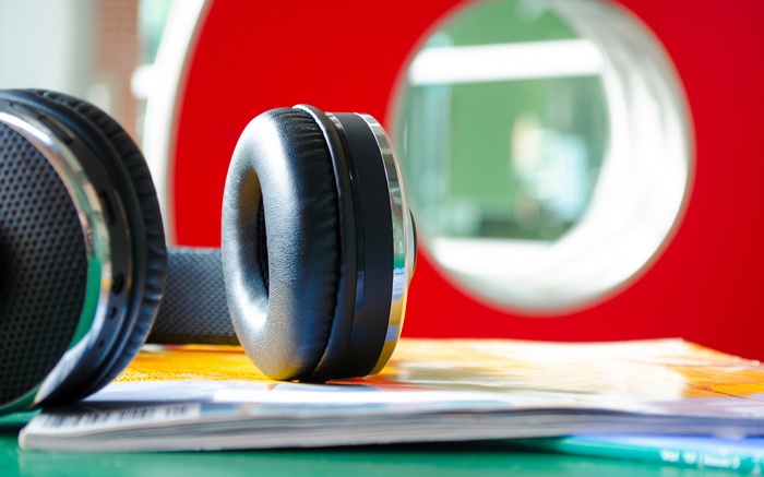 Headphones on a stack of magazines