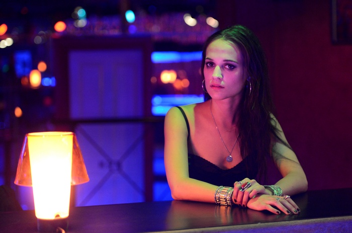 Alicia Vikander in a dimly lit bar