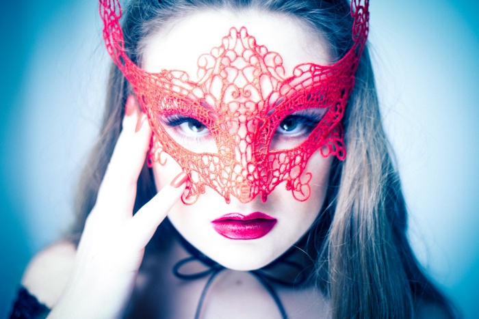 Woman wearing a red lace mask
