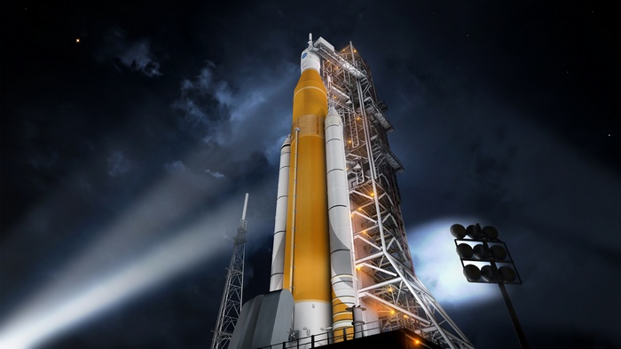 Space Launch System rocket on launchpad at night