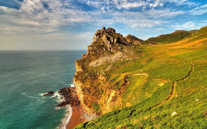 Coastal cliffs overlooking the ocean with a hiking trail