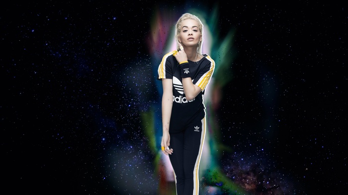Rita Ora in Adidas tracksuit against starry background
