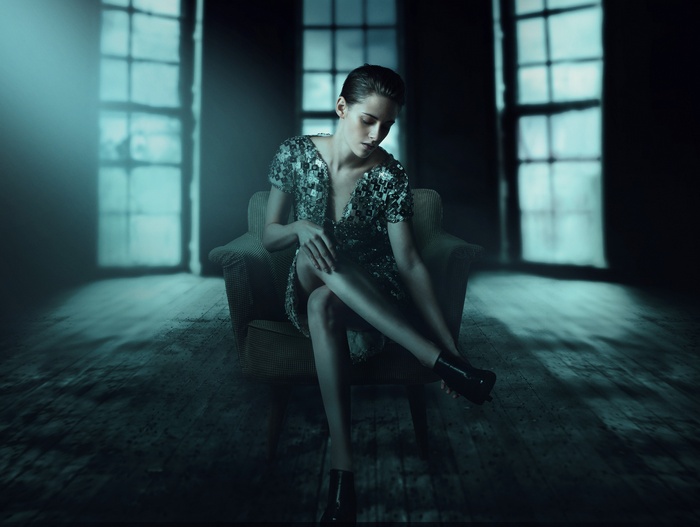 Kristen Stewart in a sequined dress sitting in a chair
