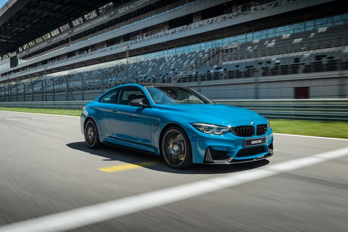 Blue 2017 BMW M4 Competition on a Race Track