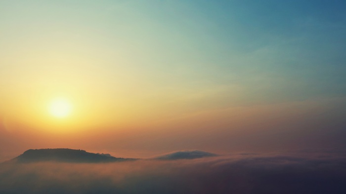 Sunset over mountains with fog, 4K