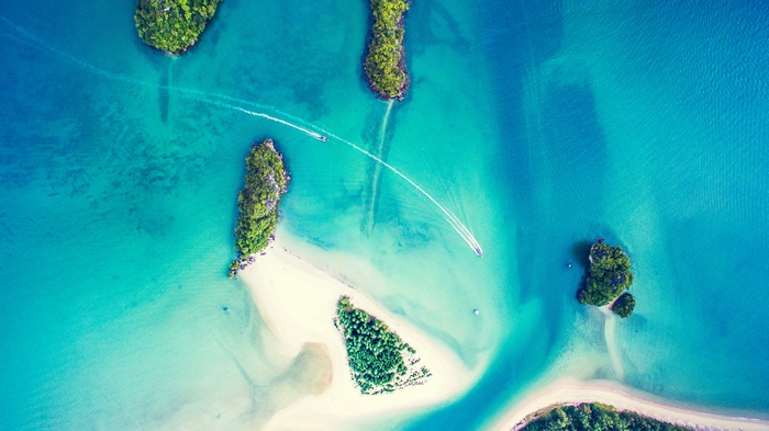 Aerial view of tropical islands and boats in turquoise water