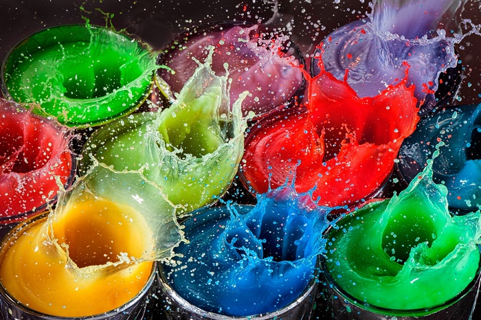 Colorful paint splashes in containers