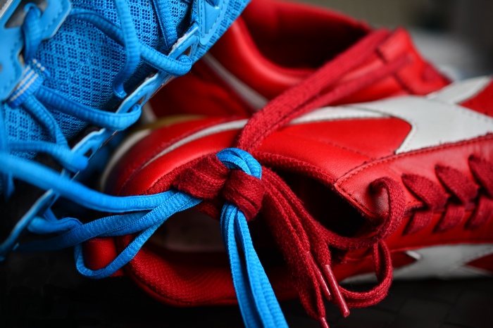 Red and blue sneakers with tied laces