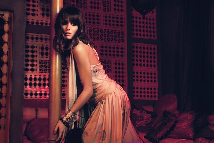 Olivia Palermo posing in a dimly lit room