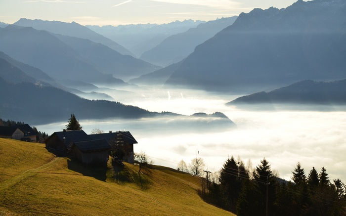 Mountain valley with fog and houses