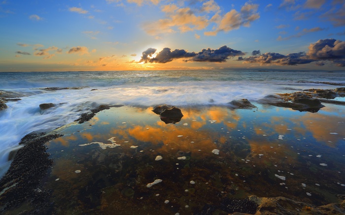 Sunset over the ocean with reflections