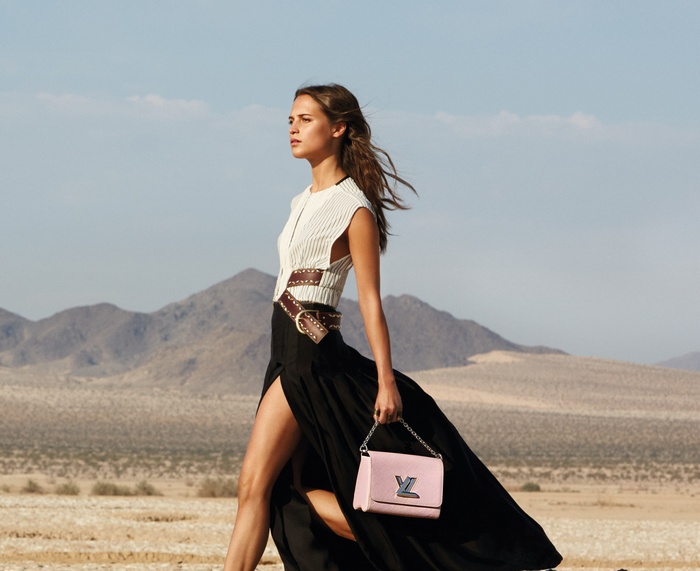 Alicia Vikander with Louis Vuitton bag in desert