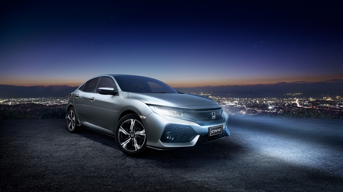 2017 Honda Civic Hatchback at night with city lights