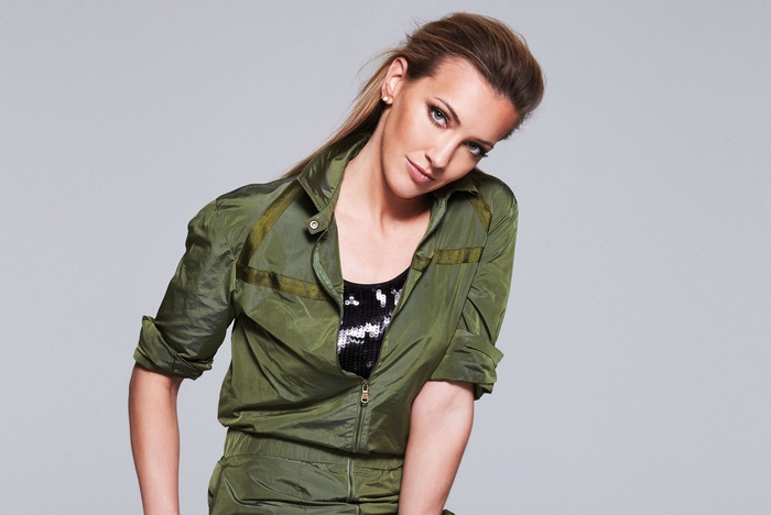 Katie Cassidy in a green jumpsuit