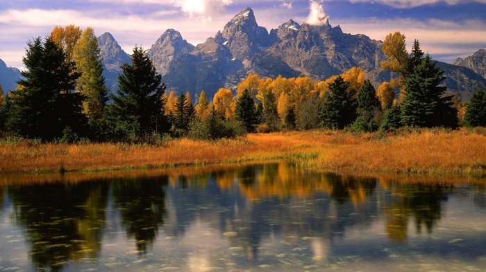 Autumn landscape with mountains and lake reflection