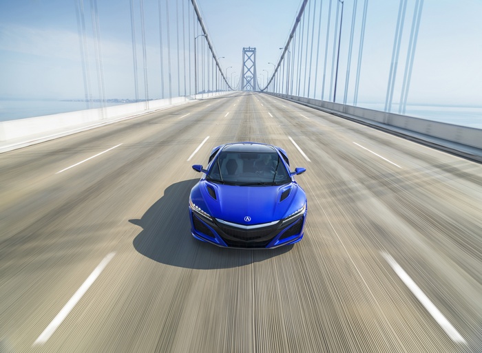 Blue 2017 Acura NSX driving on a bridge