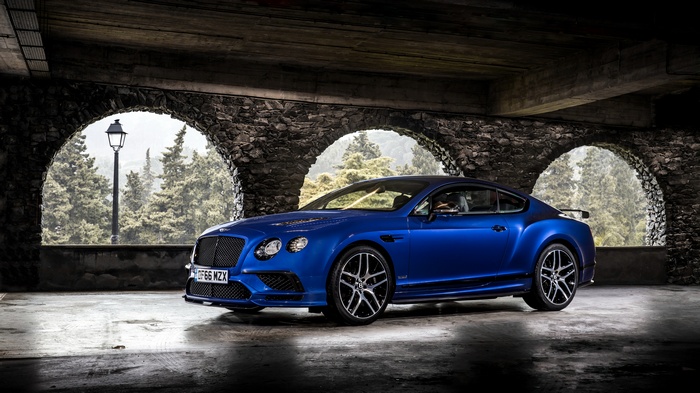 Blue Bentley Continental Supersports parked under stone arches