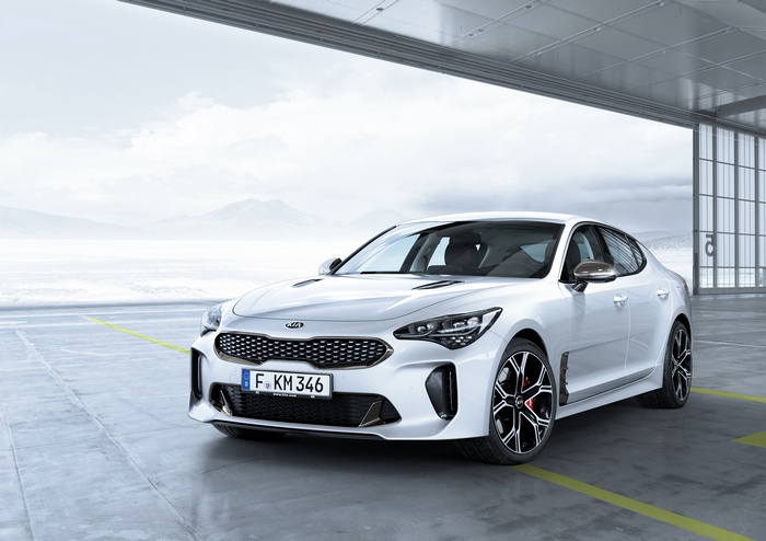 White Kia Stinger GT parked in a hangar